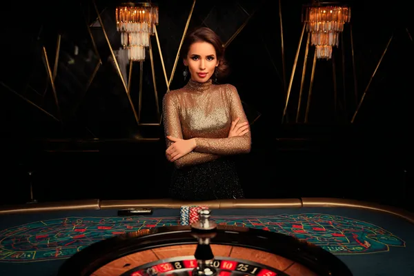 8777BET স্লটস — অপেক্ষায় আছে হাজারো রোমাঞ্চকর মেশিন উজ্জ্বল স্লট মেশিনের পাশে হাস্যোজ্জ্বল এক নারী—যা 8777BET–এর রোমাঞ্চকর স্লট সংগ্রহকে উপস্থাপন করে।